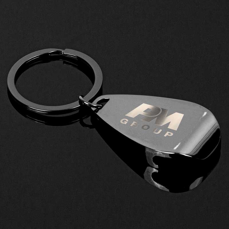 The Gunmetal Apri Bottle Opener Key Chain - For those who cherish the art of savoring life's finest moments, the Gunmetal Apri Bottle Opener Key Chain stands as a trusty companion, always ready to liberate the refreshing libations that await. It's sleek and exudes an air of sophistication and dependability. Metal is a zinc alloy with gunmetal plating. All-metal construction for enduring. Perfectly contoured for maximum bottle opening. 35mm split ring with gunmetal plating for easy attachment. Gift box included for a stylish presentation.