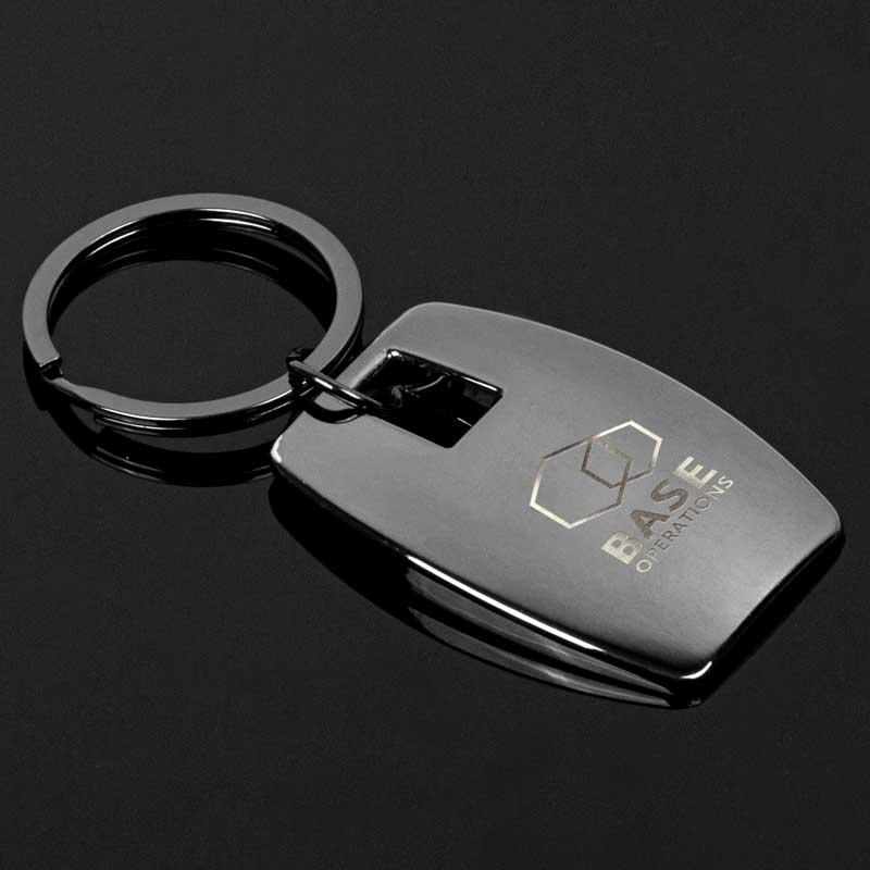 Gunmetal Messina Key Chain - The Gunmetal Messina Key Chain exudes elegance and understated sophistication. Its rounded, rectangular shape is reminiscent of a clandestine emblem, adding a touch of charm to its presence. The smooth, polished surface, devoid of any embellishments, hints at the modern design. Metal is a zinc alloy with gunmetal plating. All-metal construction for enduring elegance. Gunmetal-plated zinc alloy for a touch of inviting charm. Perfectly contoured for maximum bottle opening.